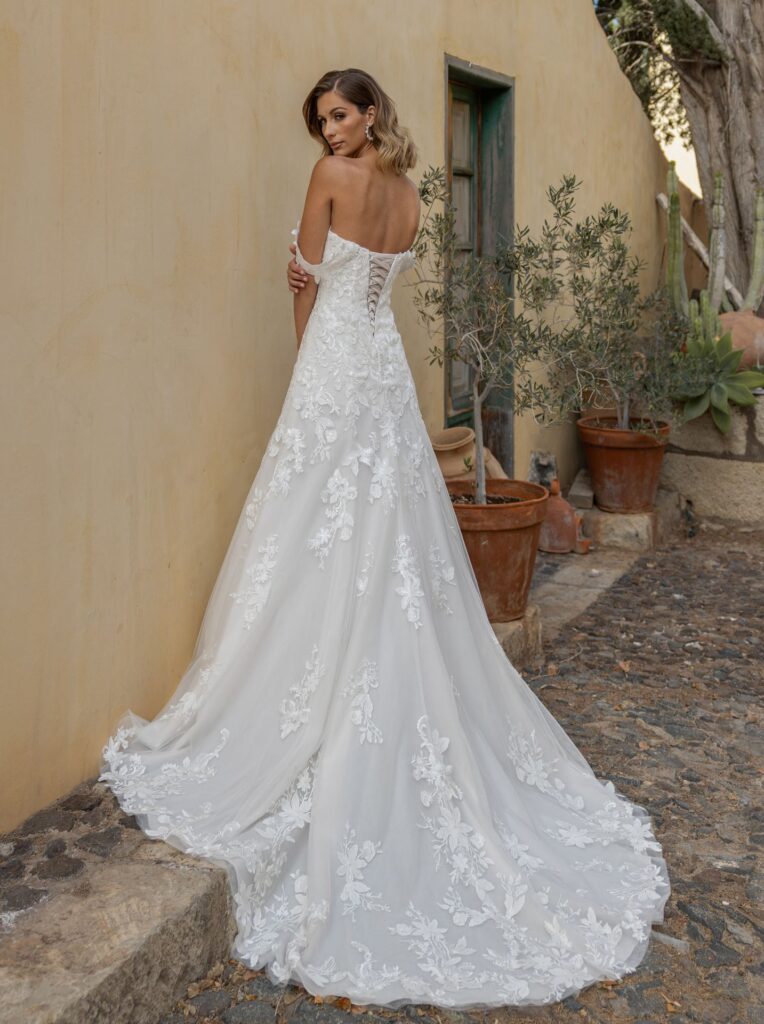 Elegantes Brautkleid mit floraler Spitze und langer Schleppe in der Brautboutique Neumünster